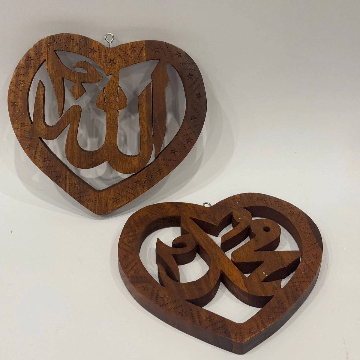 Pair of heart shaped hand carved wooden wall hangings reading Allah and Muhammad (SAW), with star and dot border detail