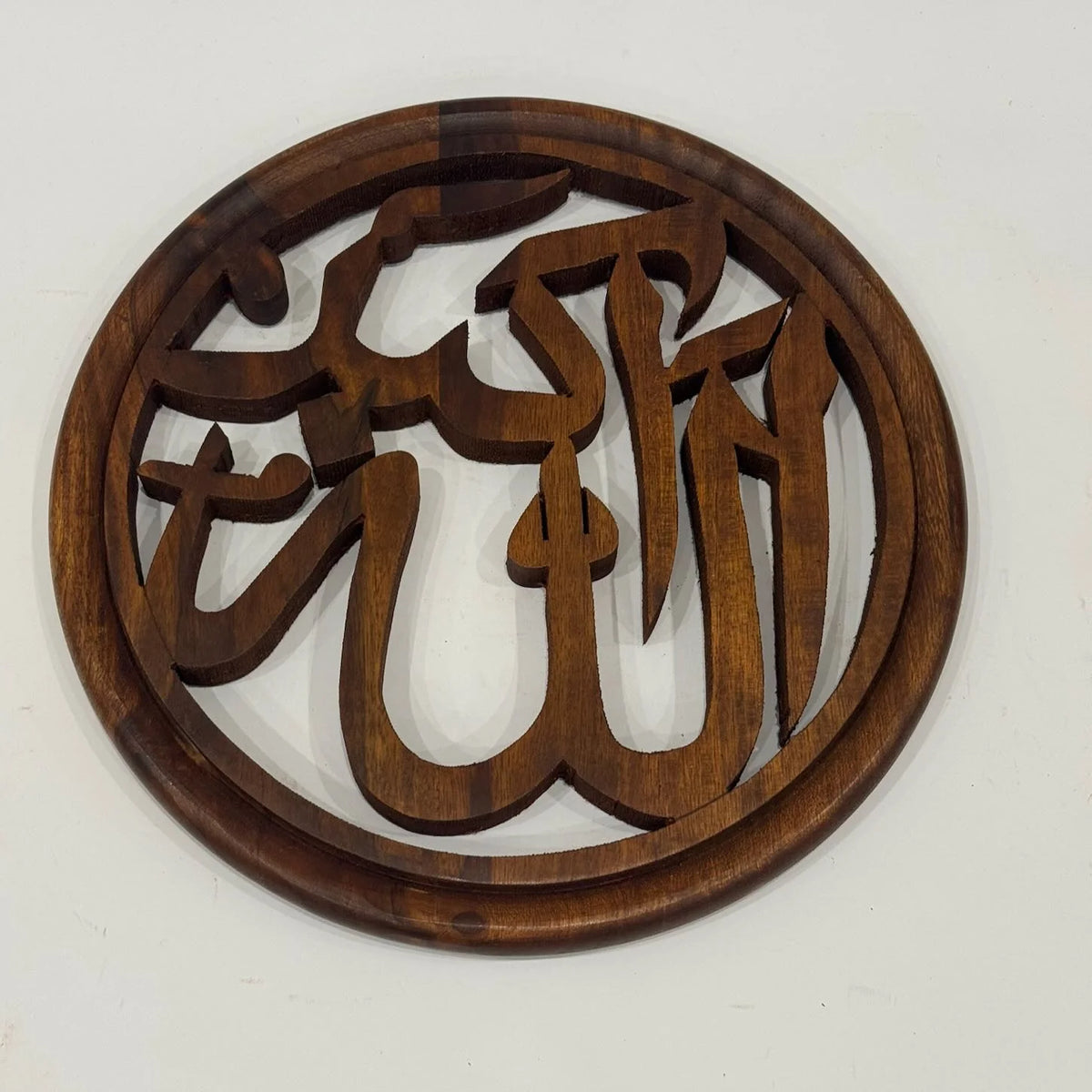 Hand carved wooden Allahu Akbar calligraphy wall art in a round frame, front view