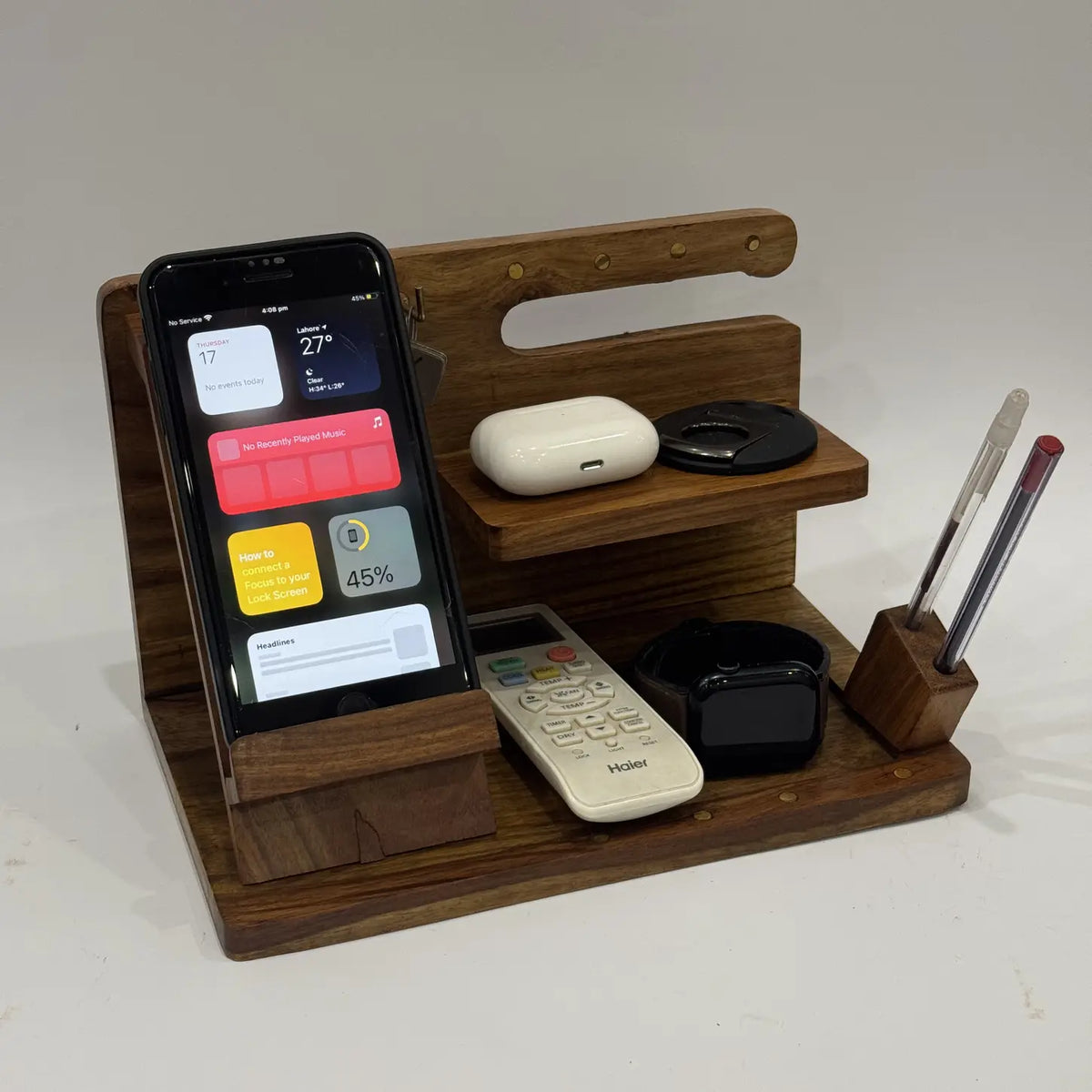Sheesham wood desk organizer with phone stand, watch rest, pen holder and shelf, holding everyday items
