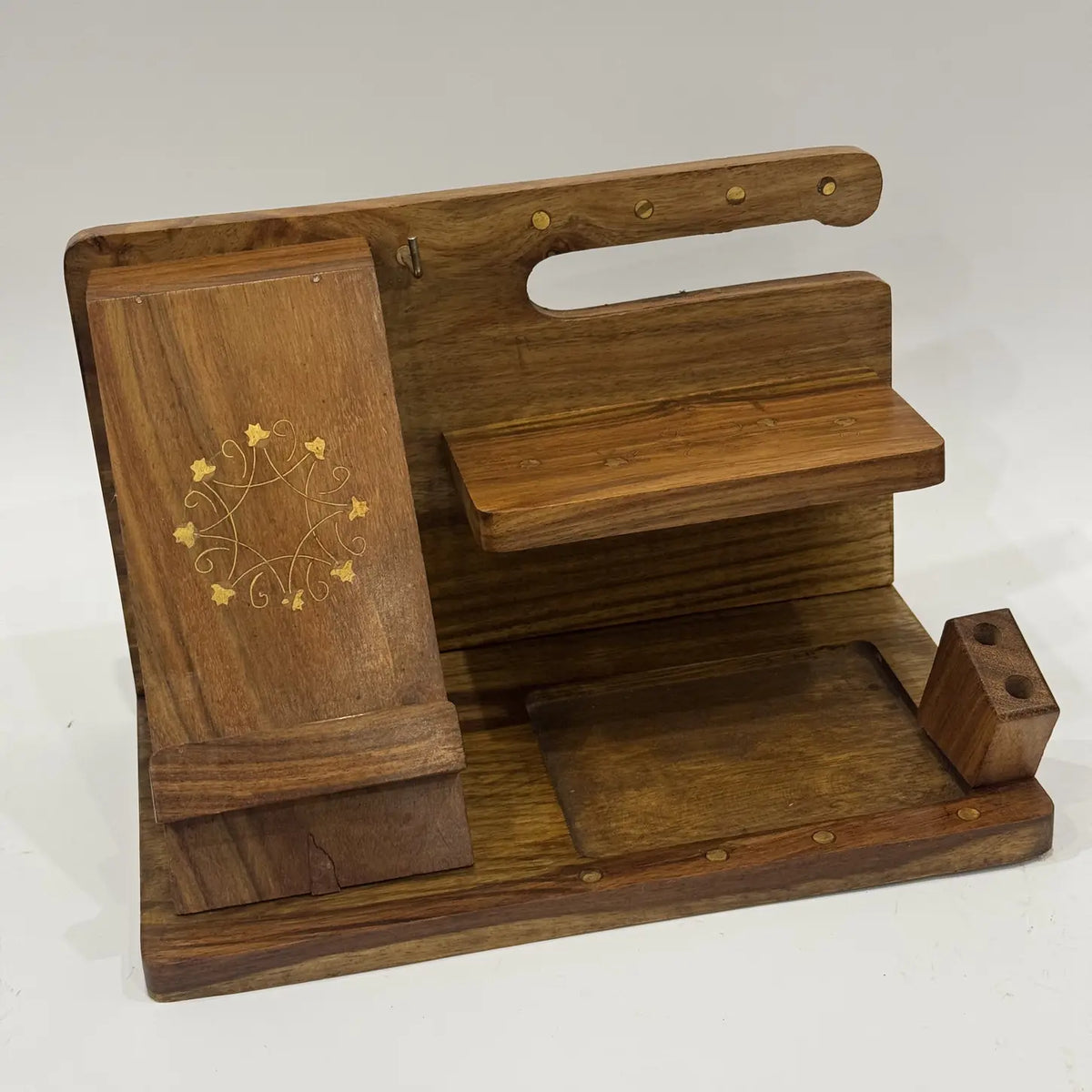 Wooden desk organizer with brass inlay on the phone stand, brass pin rail and two-hole pen block, front view
