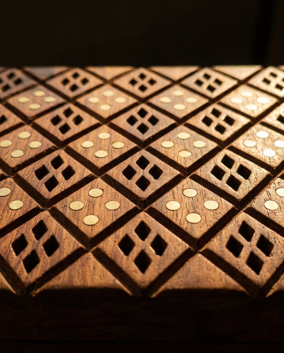 Close up of hand cut jaali diamond carving and round brass inlay on a Craft Edges sheesham wood jewellery box lid
