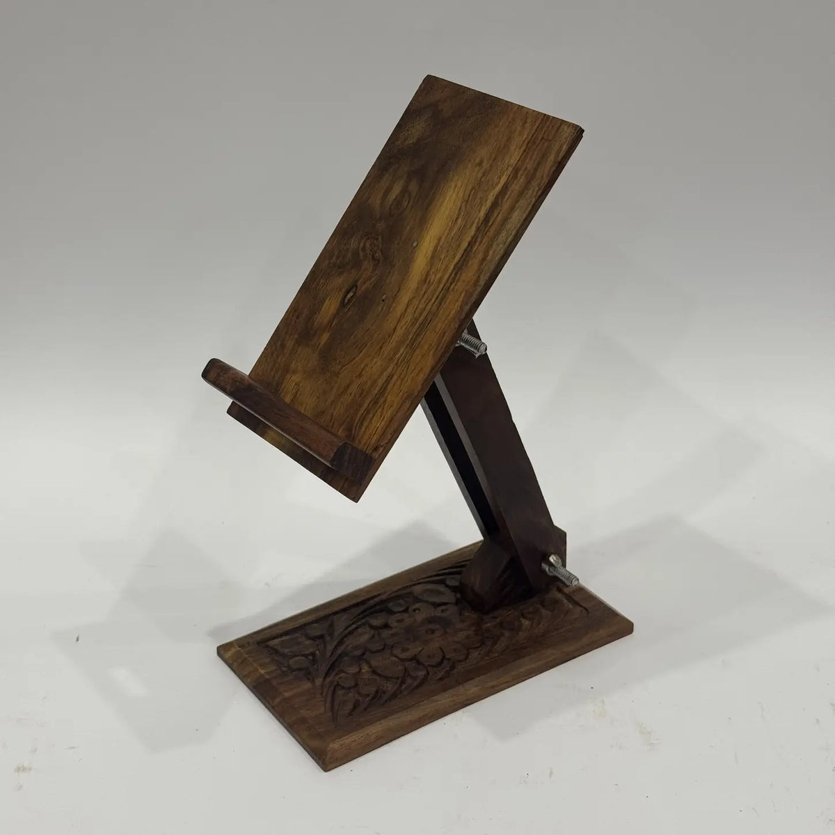 Carved wooden phone stand rear view showing adjustable arm and wing nuts