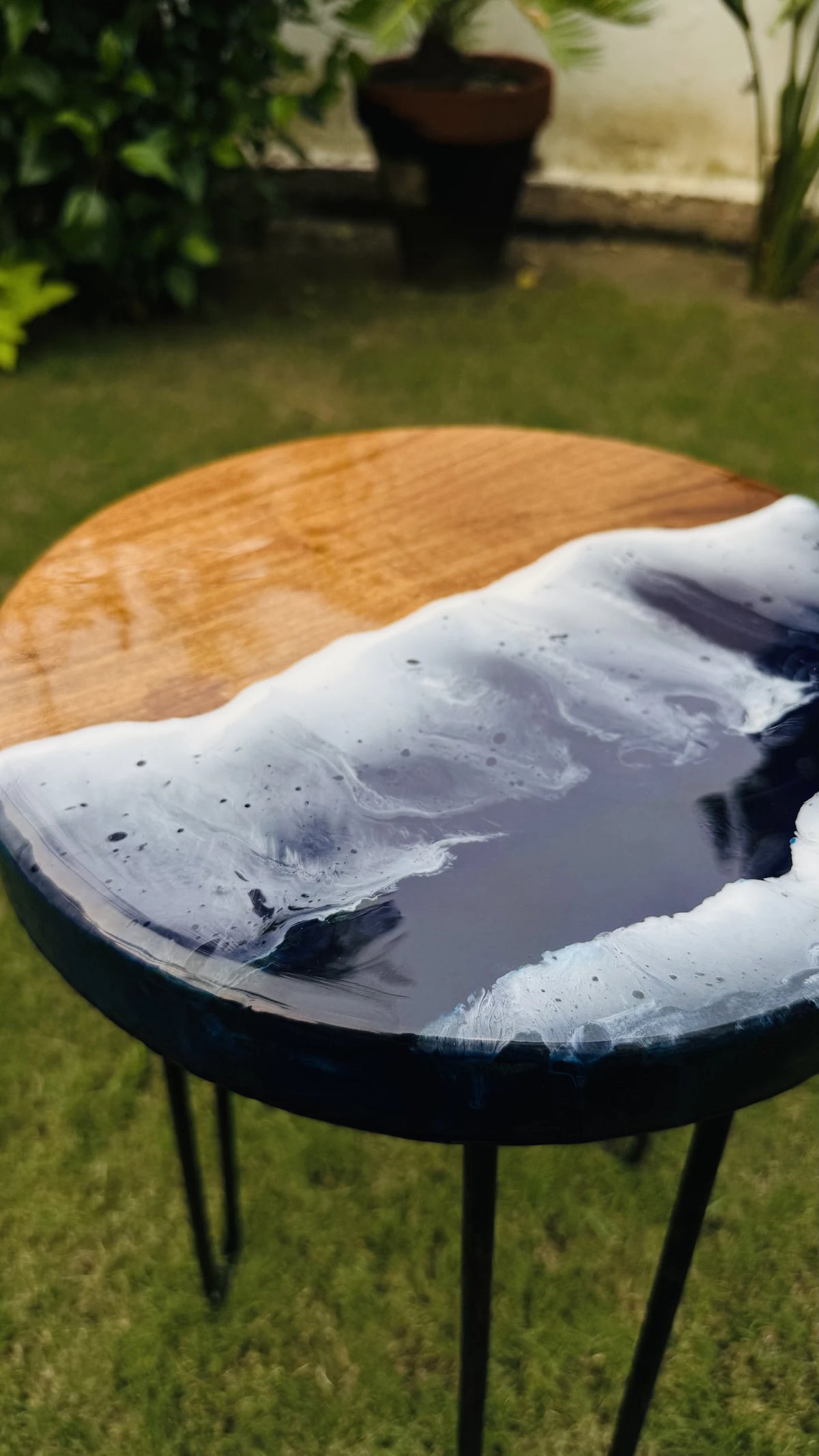 Small round wooden side table with a blue ocean resin top, handmade by Craft Edges