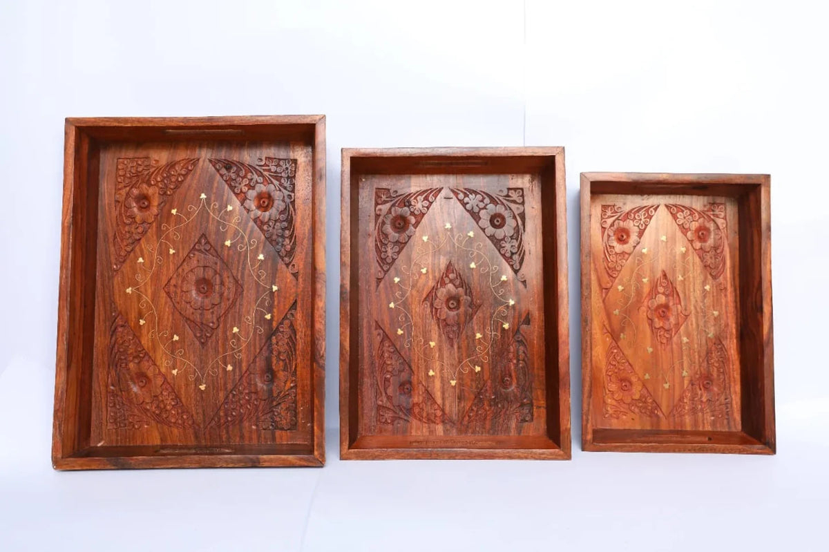 Carved and brass inlay wooden serving trays shown as a nesting set of three, Craft Edges